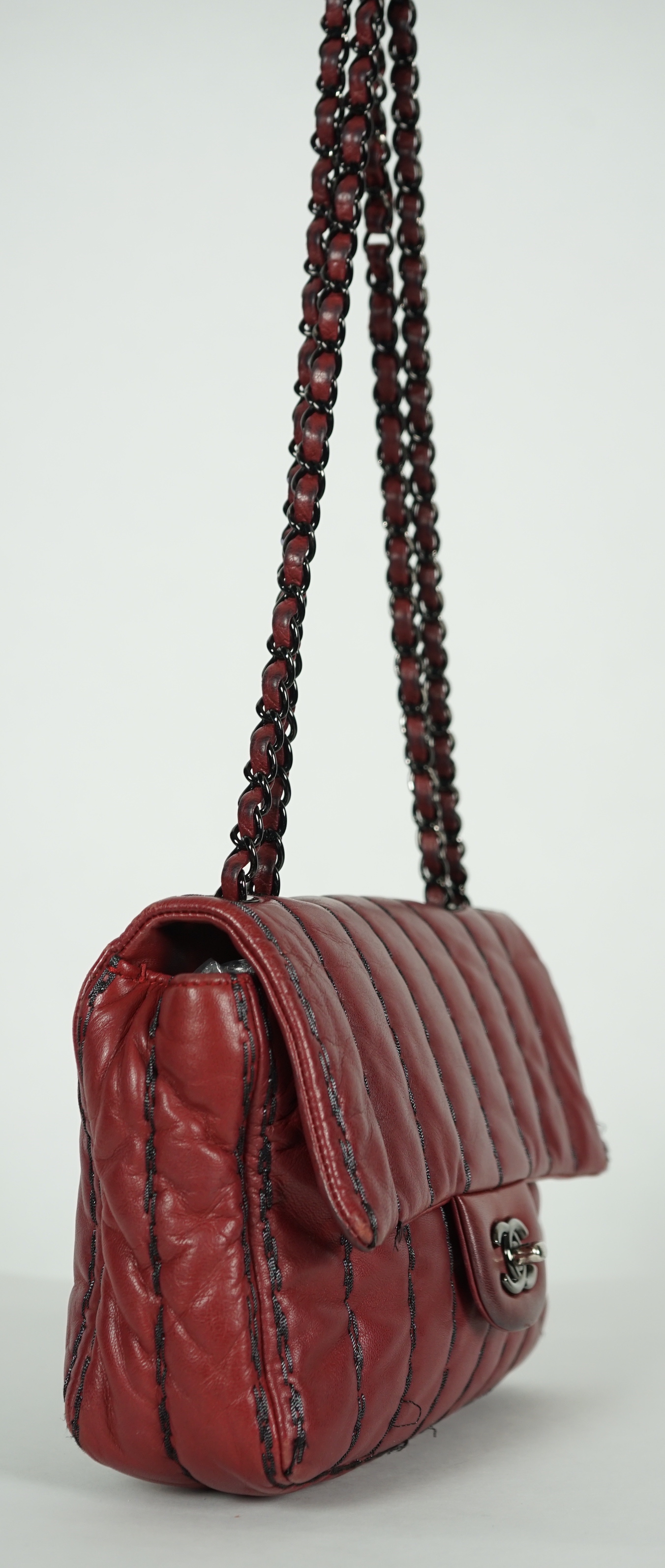 A Chanel Classic Jumbo Flap burgundy lambskin quilted shoulder bag, with pinstripe stitching, height 18cm, overall height 48cm, width 25cm, depth 6cm, Please note this lot attracts an additional import tax of 20% on the